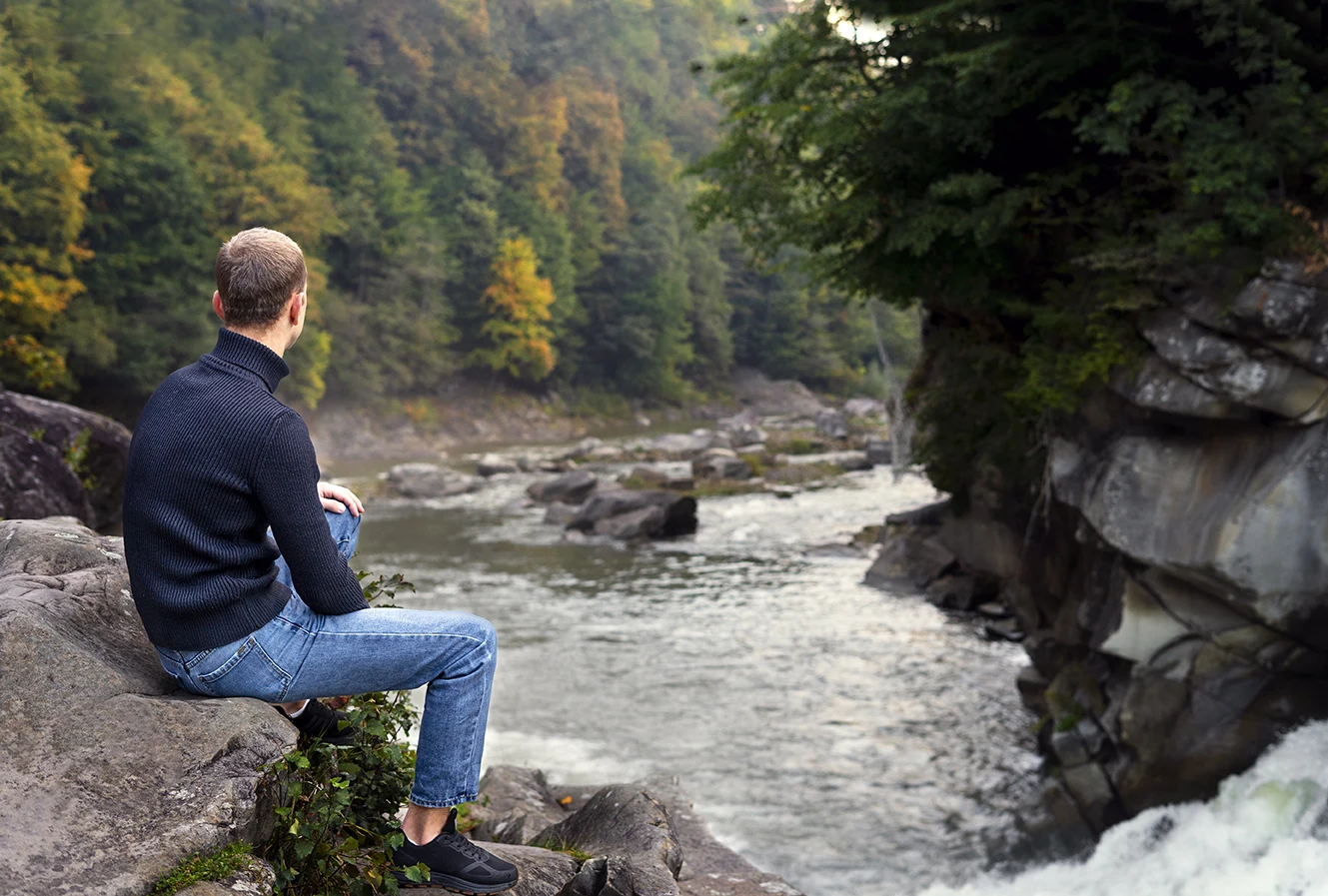 full-shot-man-sitting-rock